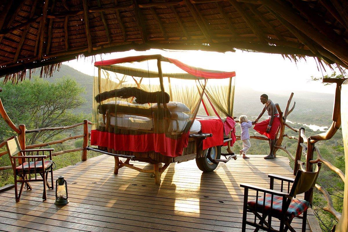 A maasai guide with a kid at Loisaba Star Bed telling tales making of a great family safari